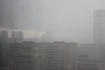 Natural Pattern of raindrops isolated on cloudy background. Rainy day. Raindrops on window glass. Close up shot on droplets of the rain on window glass.