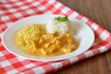 chicken stroganoff with potato straw and rice
