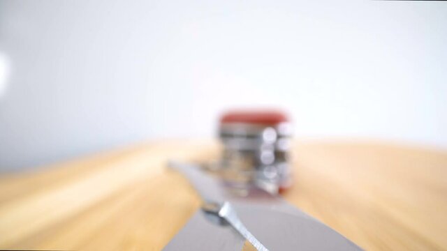 The scissor part of the swiss knife on the table