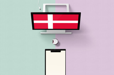 Denmark national flag on computer screen top view, cupcake and empty note paper for planning. Minimal concept with turquoise and purple background.