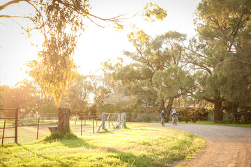 Children riding bikes on remote country lane