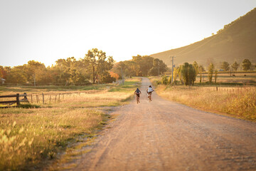 Children riding bikes on remote country lane