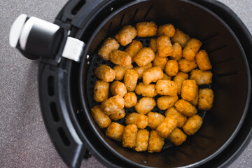 simple food ingredients, potato royals in air fryer basket shot from top down perspective