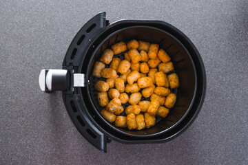 simple food ingredients, potato royals in air fryer basket shot from top down perspective