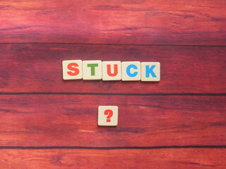 Word Stuck ? on wood background