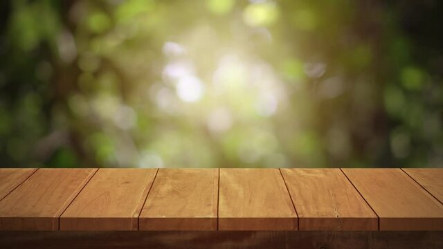 Wood table bar and nature tree bokeh blurred background, Top wood table space area for products shows. 3840x2160. 4K UHD. Video Clip.