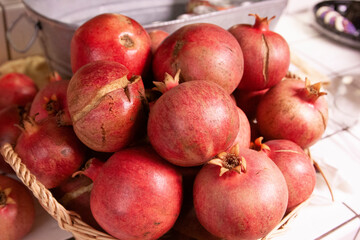 Fototapeta na wymiar Pile of red pomegranates on kitchen counter
