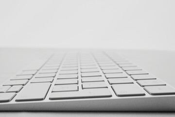 elegant and minimalist wireless keyboard on white background, perspective view