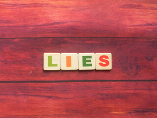 Word Lies on wood background