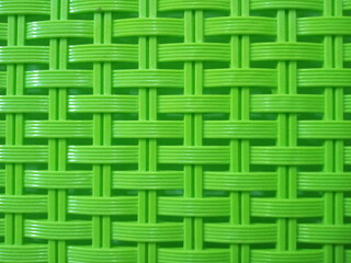 Green plastic construction background texture with woven motif