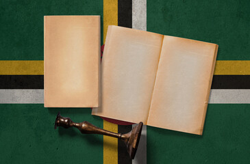 Dominica vintage historical concept. Retro craft papers and old wooden candlestick on national flag...