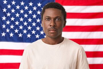 Sad African-American man near national flag of USA. Stop racism