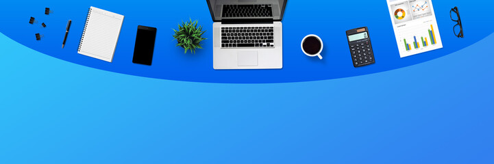 Fototapeta na wymiar Top view business office desk with laptop, coffee, notebook, a report paper, and office supplies / Creative flat lay photo of workspace desk and copy space / Panoramic banner blue background