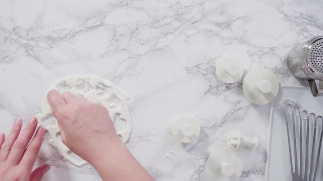 Flat lay. Step by step. Rolling our white fondant on a marble counter.