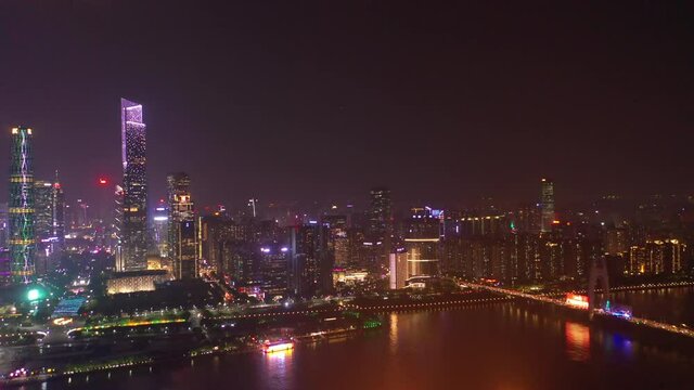 night illuminated guangzhou city modern downtown famous towers riverside bay aerial panorama 4k china