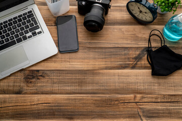 Vintage office desk table with laptop, smartphone and other supplies. Concept in pandemic covid 19.