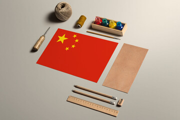 China calligraphy concept, accessories and tools for beautiful handwriting, pencils, pens, ink, brush, craft paper and cardboard crafting on wooden table.