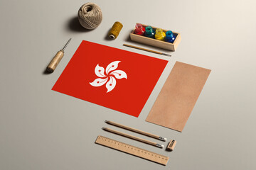 Hong Kong calligraphy concept, accessories and tools for beautiful handwriting, pencils, pens, ink, brush, craft paper and cardboard crafting on wooden table.