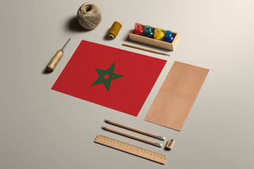 Morocco calligraphy concept, accessories and tools for beautiful handwriting, pencils, pens, ink, brush, craft paper and cardboard crafting on wooden table.