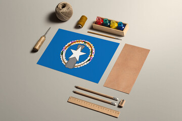 Northern Mariana Islands calligraphy concept, accessories and tools for beautiful handwriting, pencils, pens, ink, brush, craft paper and cardboard crafting on wooden table.