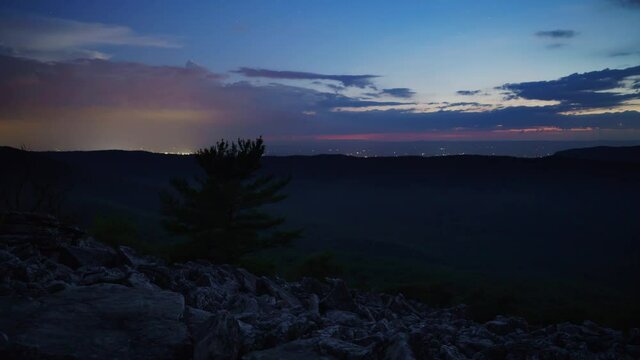 A sunset, nighttime stars and sunrise time lapse from the talus field on the west side of Duncan Knob, in the Massanutten Range, part of the George Washington National Forest in Page County Virginia.