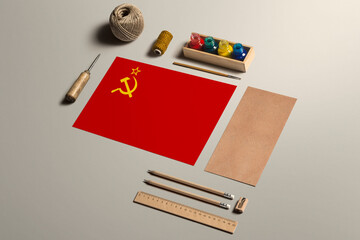 Soviet Union calligraphy concept, accessories and tools for beautiful handwriting, pencils, pens, ink, brush, craft paper and cardboard crafting on wooden table.