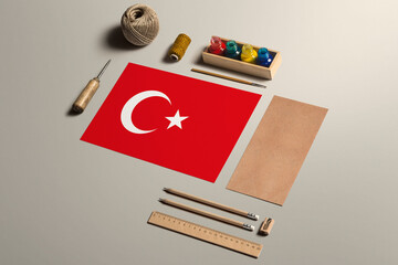 Turkey calligraphy concept, accessories and tools for beautiful handwriting, pencils, pens, ink, brush, craft paper and cardboard crafting on wooden table.
