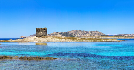 Panoramic view of the ancient watchtower in front of the beach named "La Pelosa" in Stintino, Italy