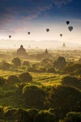 Rolgordijnen Hot air balloon over plain of Bagan in misty morning, Myanmar at sunrise © MERCURY studio