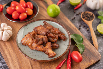 Pork cutlet in a white plate on black cement.