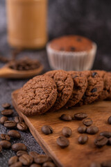 Cookies with coffee beans placed on a wooden plate.