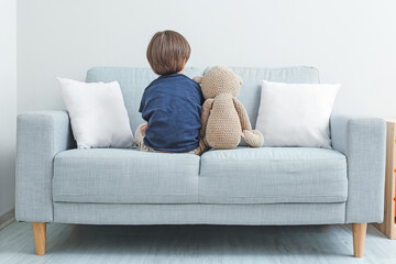 Sad little boy with autistic disorder at home