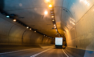 Middle rig semi truck transporting local cargo in box semi trailer running on the road through the...