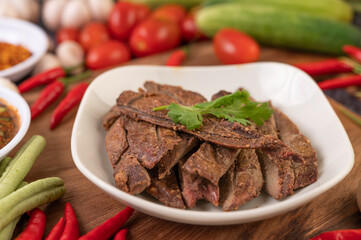 Grilled pork liver in a white plate.