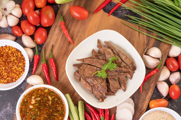 Grilled pork liver in a white plate.