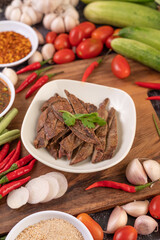 Grilled pork liver in a white plate.