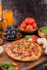 pizza placed on a wooden plate.