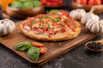 pizza placed on a wooden plate.