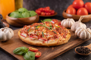 pizza placed on a wooden plate.