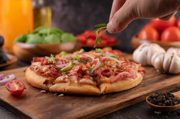pizza placed on a wooden plate.