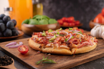 pizza placed on a wooden plate.