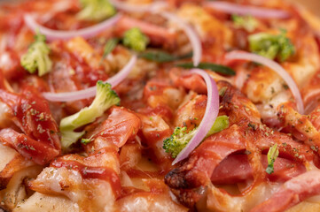 pizza placed on a wooden plate.