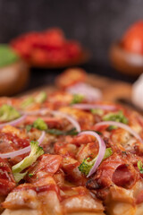 pizza placed on a wooden plate.