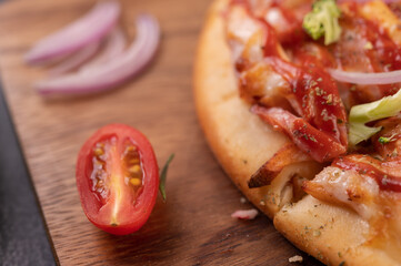 pizza placed on a wooden plate.