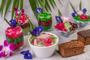 Desserts in cups placed on cement floor.