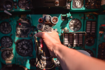 unrecognizable person hand holding joystick of old Soviet military Mig-21 jet airplane parking in park next to military museum © Juan Alberto Ruiz