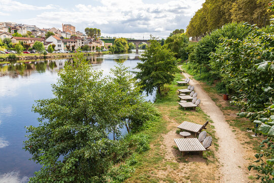 Chaise lounges on a pathway along the Vienne River in Limoges.