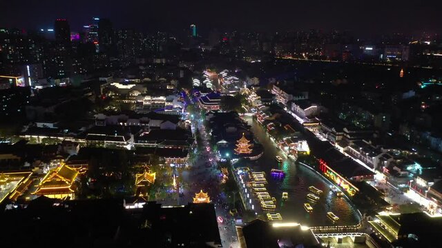 night time illuminated nanjing city famous old town district river aerial panorama 4k china