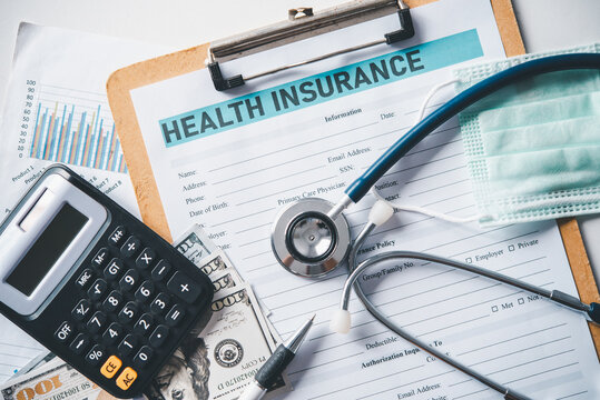 Stethoscope and calculator placed on health insurance documents, Individual medical health insurance. Concept life planning