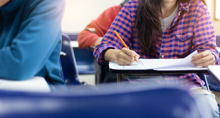 high school,university student study.hands holding pencil writing paper answer sheet.sitting lecture chair taking final exam attending in examination classroom.concept scholarship for education abroad